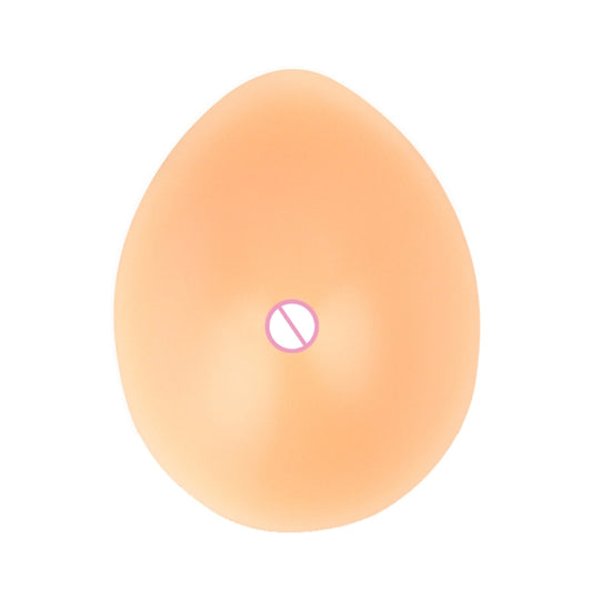 Drop-shaped silicone breast prosthesis, flesh tone, smooth surface with nipple detail.