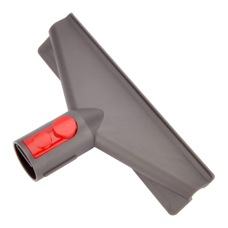 Gray vacuum brush head with wide nozzle and red power button controls.