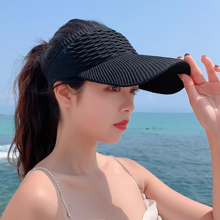 Black ribbed peaked sun cap for women with curved brim and breathable knit panel.