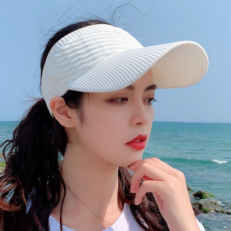 White ribbed peaked sun cap for women with curved brim and breathable knit texture.