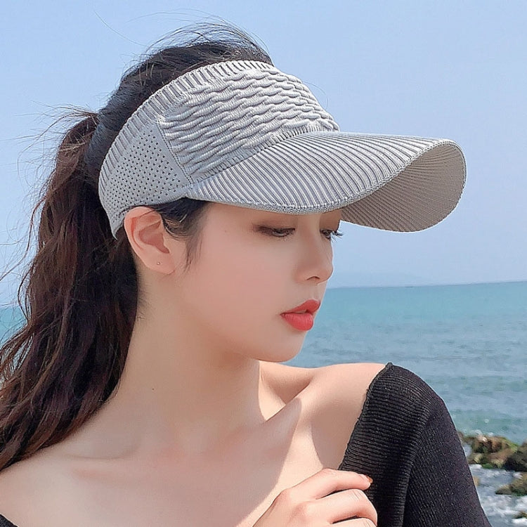 Light gray ribbed peaked sun cap with curved brim and breathable knit crown.