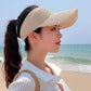 Beige ribbed peaked sun cap with curved brim and breathable knit ventilation texture.