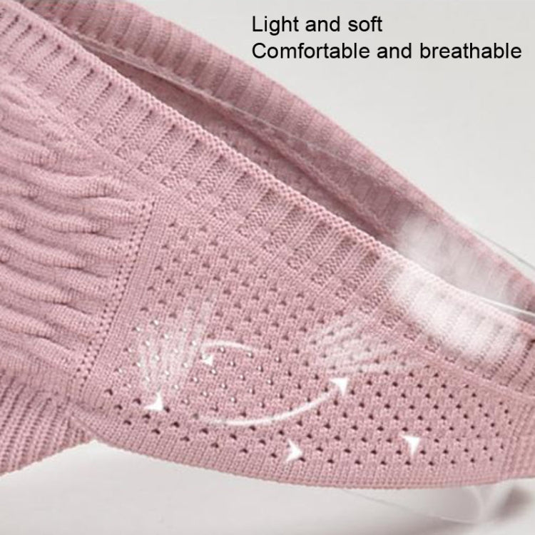 Pink knit peaked cap close-up showing ribbed texture and breathable ventilation holes.