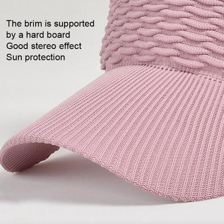 Pink sun cap brim with ribbed knit texture and rounded edge profile.