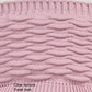 Pink ribbed knit peaked cap fabric close-up