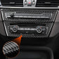 Installed carbon-fiber center console trim over radio and climate controls, close-up