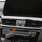 Carbon fiber radio panel trim sticker on vent controls, partial close-up