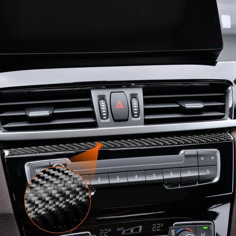 Installed carbon fiber-look radio panel upper trim strip with weave texture detail