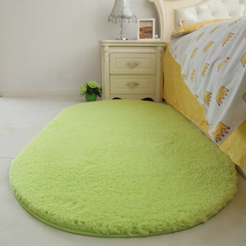 Green oval plush pet bed pad with velvety shag texture