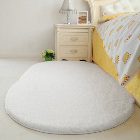 White oval plush pet bed pad with soft fluffy surface