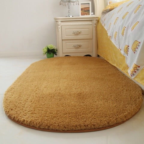 Tan oval plush pet bed pad with fuzzy shag texture