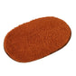 Brown oval plush pet bed pad with soft shag pile and flat surface