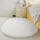 White oval plush pet bed pad with soft shag pile and flat surface