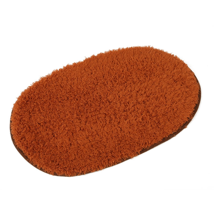 Brown plush pet bed pad with shag texture and rounded oval shape