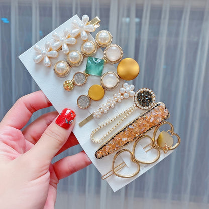 Pearl and rhinestone hair clip set with bow, round beads, and gold pins
