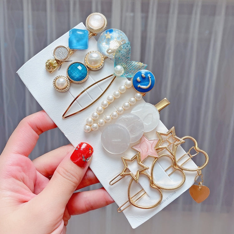 Blue-themed hair clip set with smiley charm, pearls, and rhinestone star grips