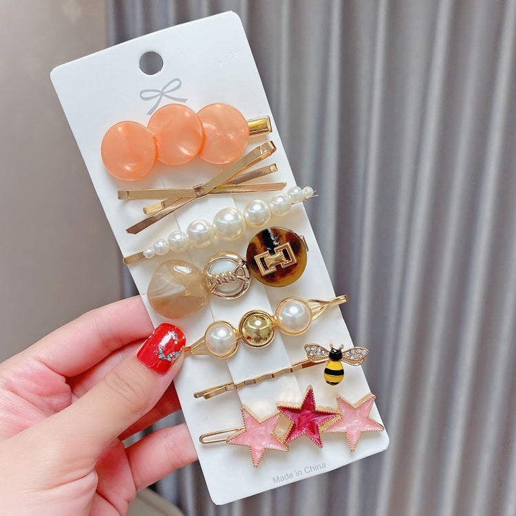 Peach and pearl hair clip set with heart discs, bee charm, and star pins