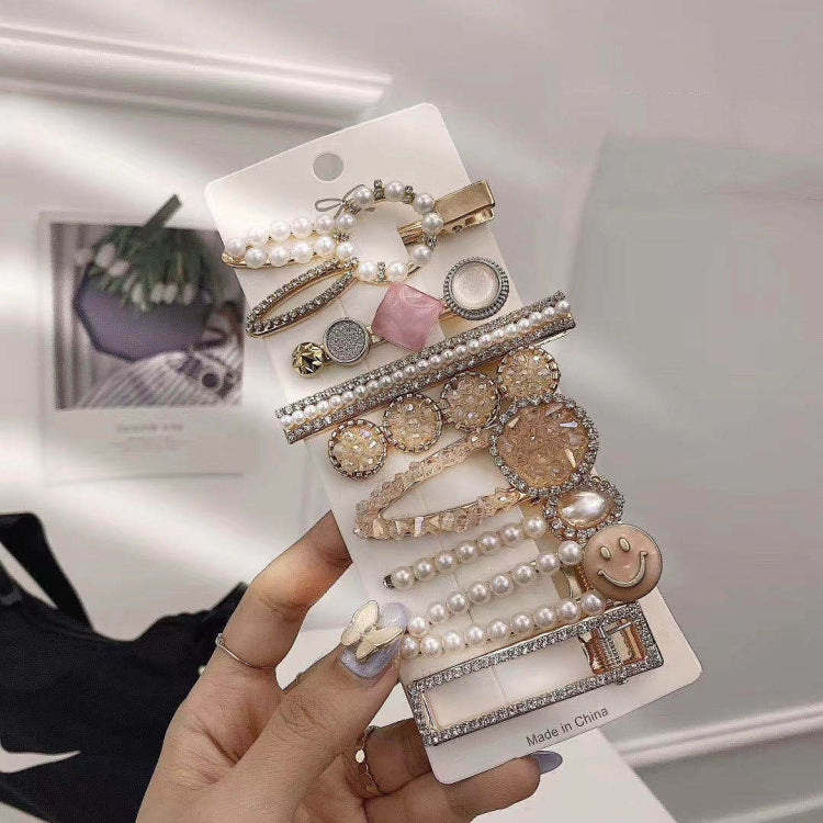 Pearl and rhinestone hair clip set with gold-tone barrettes and charm details