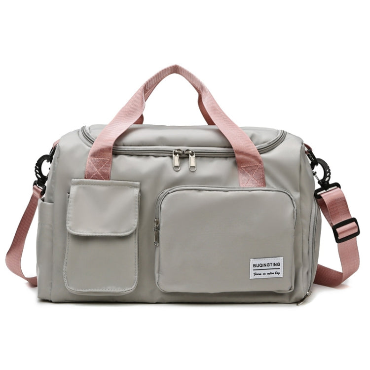 Light grey waterproof travel gym bag with front zip pocket and pink shoulder straps