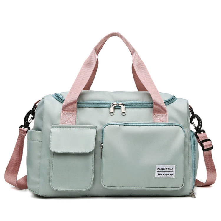 Seafoam green waterproof travel gym bag with front zip pocket and pink shoulder strap