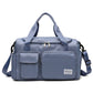 Slate blue waterproof travel gym bag with front zip pocket, dual handles, and shoulder strap