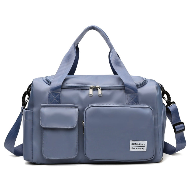 Slate blue waterproof travel gym bag with front zip pocket, dual handles, and shoulder strap