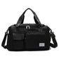 Black waterproof travel duffel bag with front pockets, top zipper, and shoulder strap