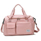 Pink waterproof travel duffel bag with front pockets, zip top, and adjustable shoulder strap