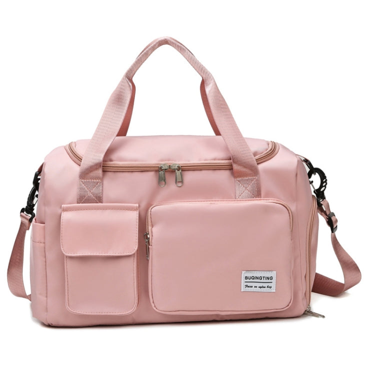 Pink waterproof travel duffel bag with front pockets, zip top, and adjustable shoulder strap