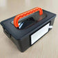 Robot vacuum filter compartment with white HEPA filter and orange pull handle