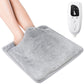 Silver gray electric foot warmer pad placed under feet with controller nearby