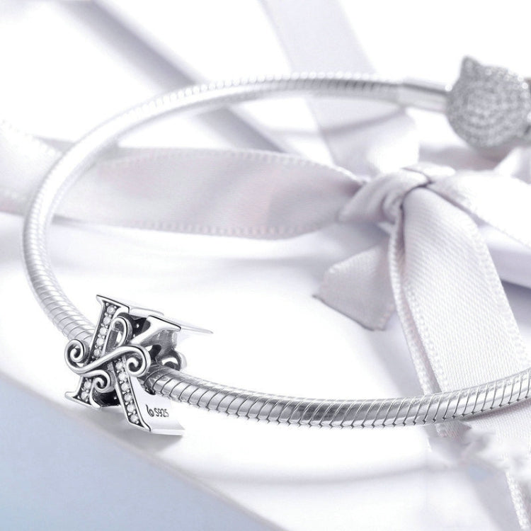 Silver charm bracelet with letter charm featuring zircon inlay detail