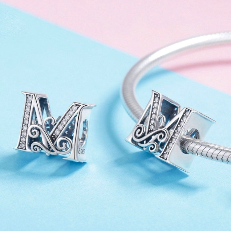 Two silver letter charms on a bracelet, black enamel with zircon sparkle