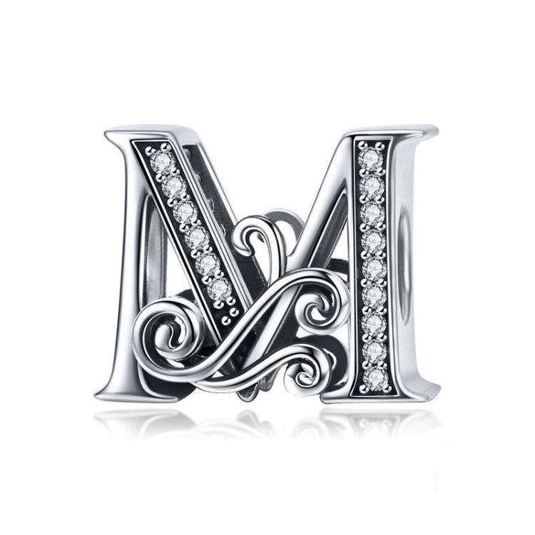 Silver-tone letter charm with black enamel and rhinestone accents, cursive “M” style