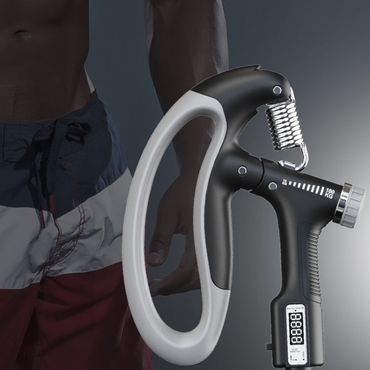 Electronic grip arm trainer held on arm with controller display visible
