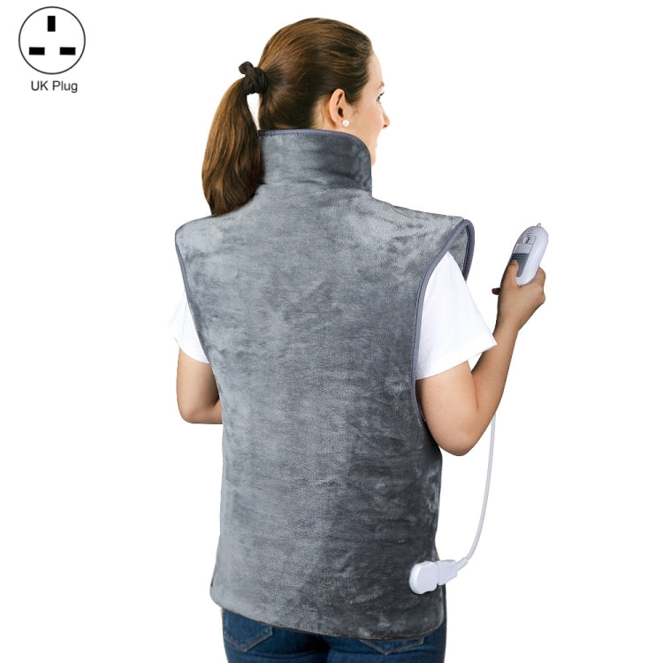 Heated shoulder and neck guard vest worn on shoulders with controller in hand