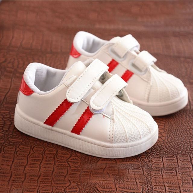 Kids white sneakers with red side stripes and double hook-and-loop straps