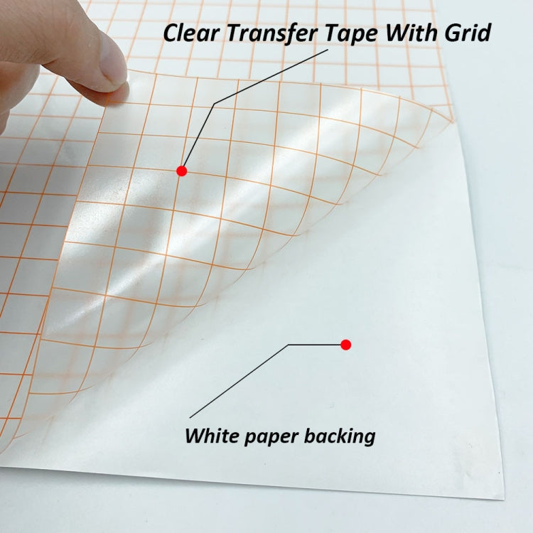 Clear transfer vinyl sheet with orange grid, held by fingers over white backing