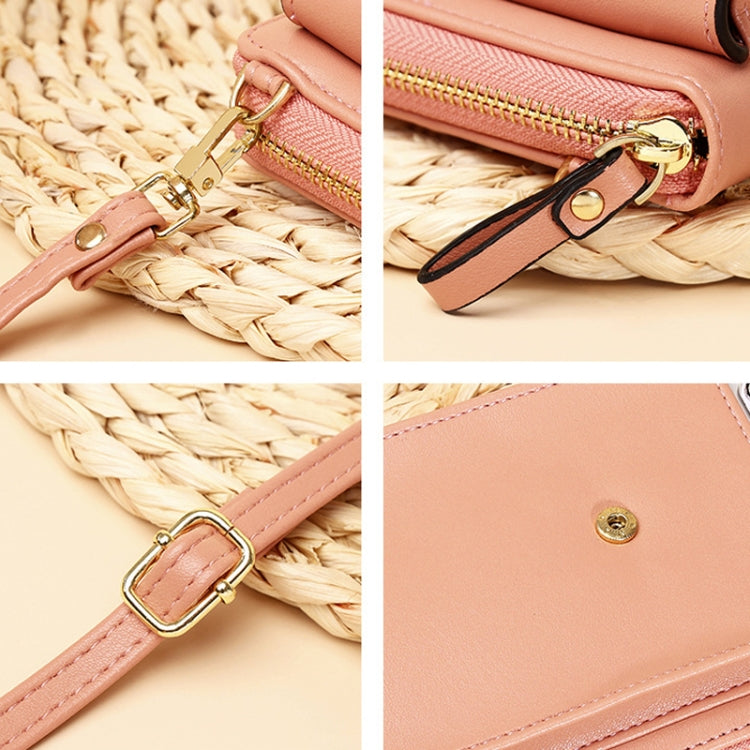 Pink crossbody bag detail: gold zipper pull and D-ring strap hardware.