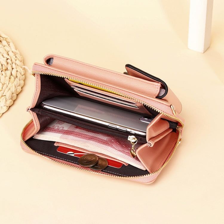 Blush pink crossbody bag open to show card slots and a zip compartment.