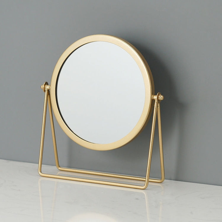 Desktop makeup mirror with round glass and gold frame, on a folding A-frame stand