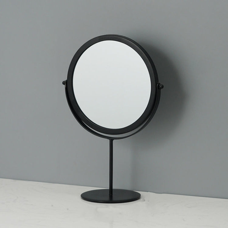 Desktop makeup mirror with round glass and black frame, on a black circular base