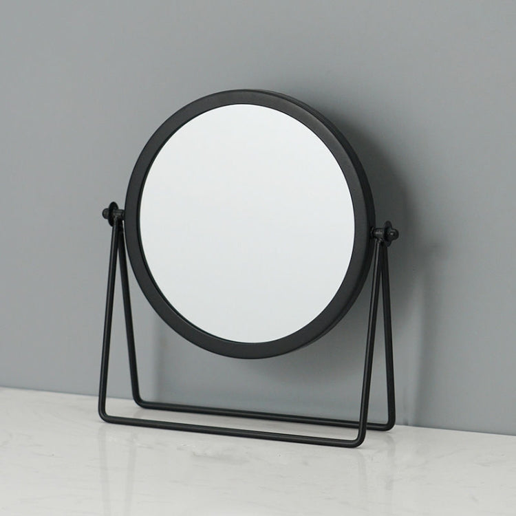 Desktop makeup mirror with round glass and black frame, on a folding black A-frame stand