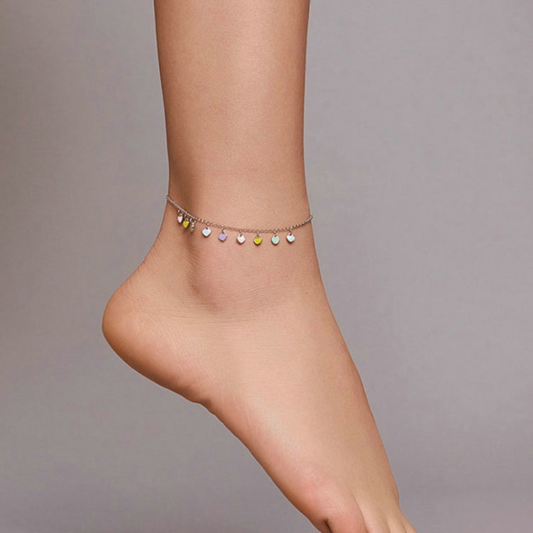 Silver anklet with multicolor heart charms on the ankle
