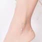 Silver cat bell anklet on ankle with small bell and ring-style clasp