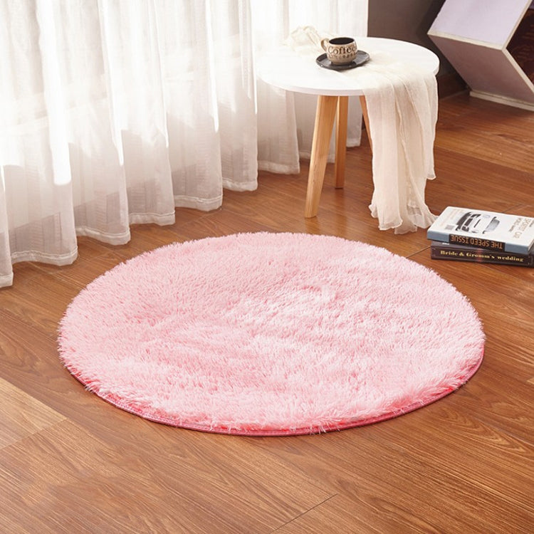 Pink round plush pet electric heating pad on floor