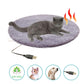 Gray cat resting on round purple plush pet heating pad with USB cable