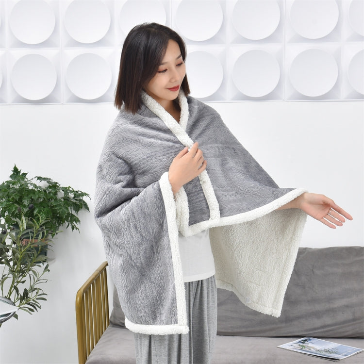 Light grey flannel shawl blanket with white fleece-lined edge, draped over shoulders