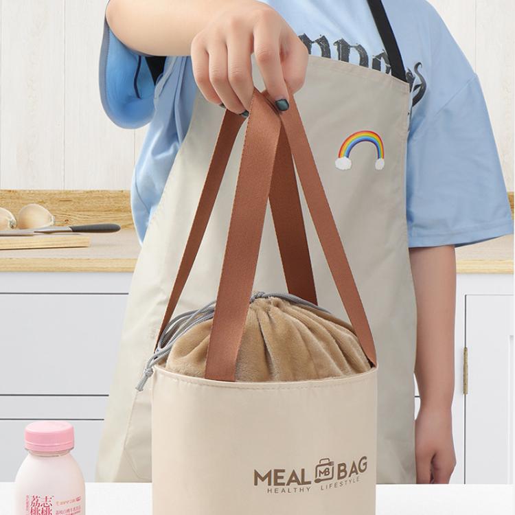 Round insulated lunch bag lifted by brown handles, beige exterior with drawstring