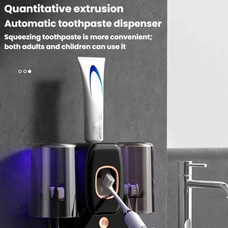 Wall-mounted UV toothbrush sanitizer rack with white toothpaste dispenser tube and brush slots